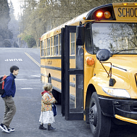 All traffic must stop for a school bus when it is alighting or taking on passengers and its red lights are flashing.