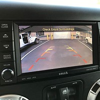 You can use a backup camera for your driver's test, but not as your main line of sight when reversing. Glance at it the way you would your mirrors.