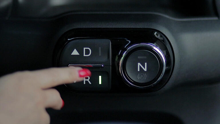 The car must be at a complete stop with your foot on the brake to put the transmission into reverse.