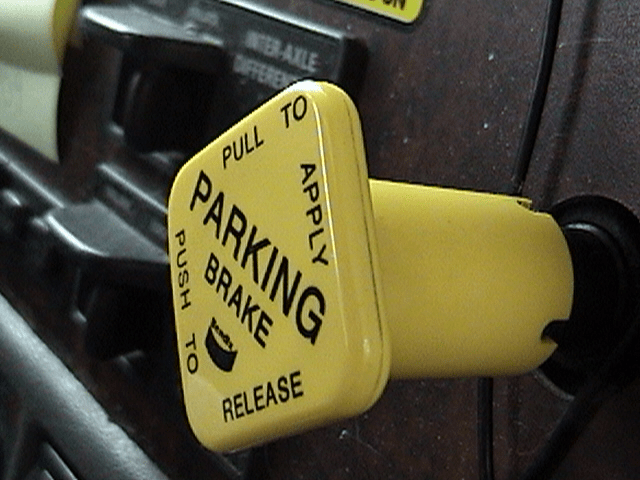 The yellow 4-sided parking control vavle.<p>This valve controls the vehicle's parking brakes by exhausting and supplying air to the spring brake chamber.