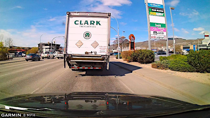 Don't blindly follow large vehicles that are blocking your view. Stay back so that you can scan the intersection.