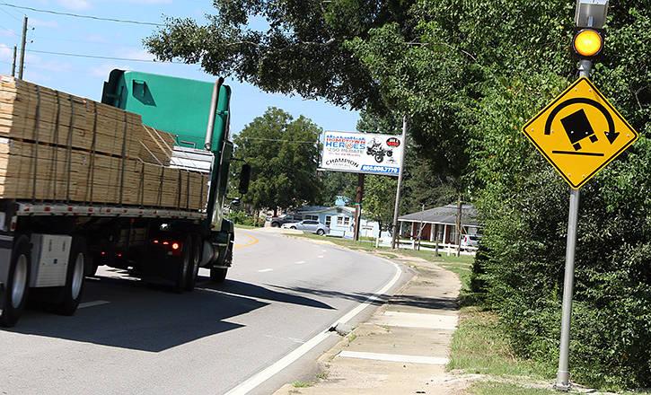 If you're unfamiliar with a roadway, follow the advisory speed for negotiating the corner until you become accustomed to the road and the truck.