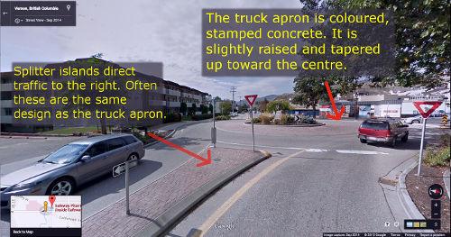 Small roundabout with truck apron designed to provide extra space for larger vehicles that are turning.