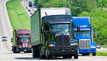 Semi-trucks are just another vehicle on the road. Focus on what you're doing and get behind or in front of these vehicles.
