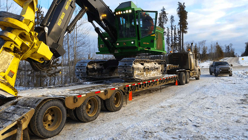 Hauling a drop deck in the oil fields, you're going to move some large logging equipment.