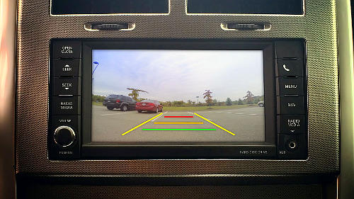 You can use a backup camera for a driver's test, but not as your main light of sight.