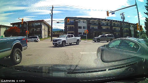 Always stop behind the STOP line when waiting at intersections.