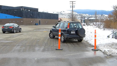 When parallel parking with cones, you'll bring the front end into the space when the front cone is just past the 'A' pillar on the passenger's side. This part may require adjustment depending on your vehicle.